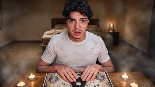 Scared creator at a Ouija board lit by candles